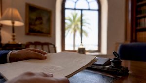 Hands holding Spanish property escritura deed