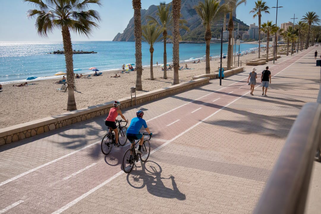 Cyclists and walkers on Calpe seafront promenade