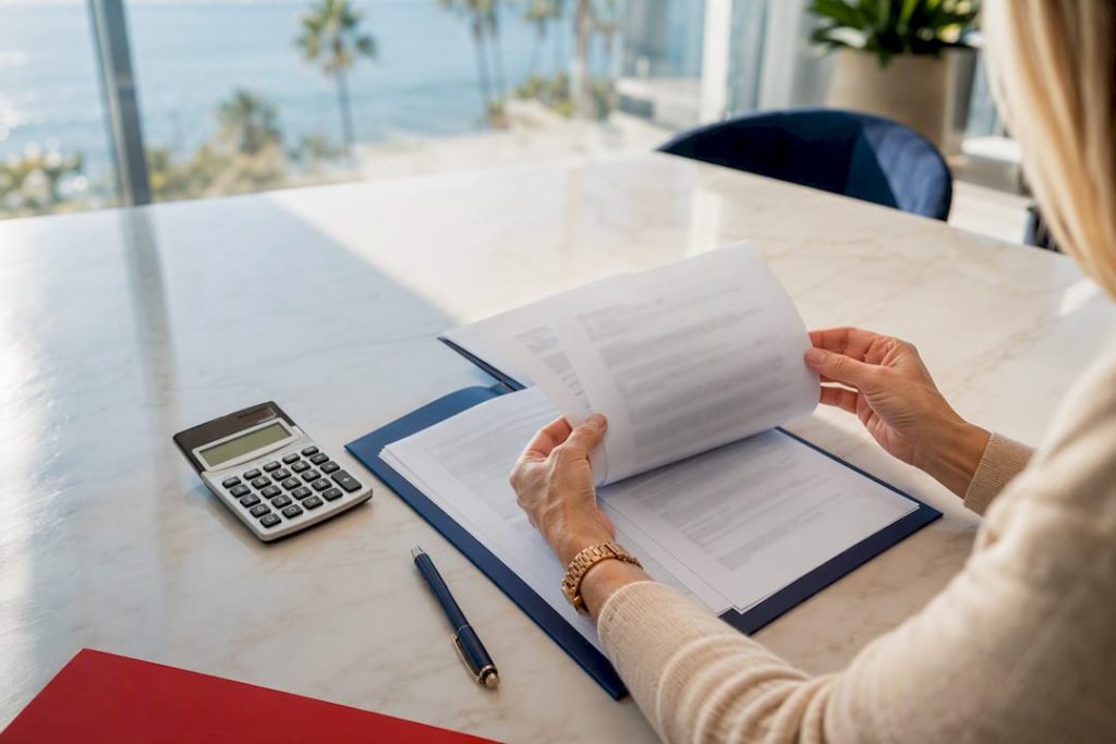 Hands reviewing Spanish property fee terms